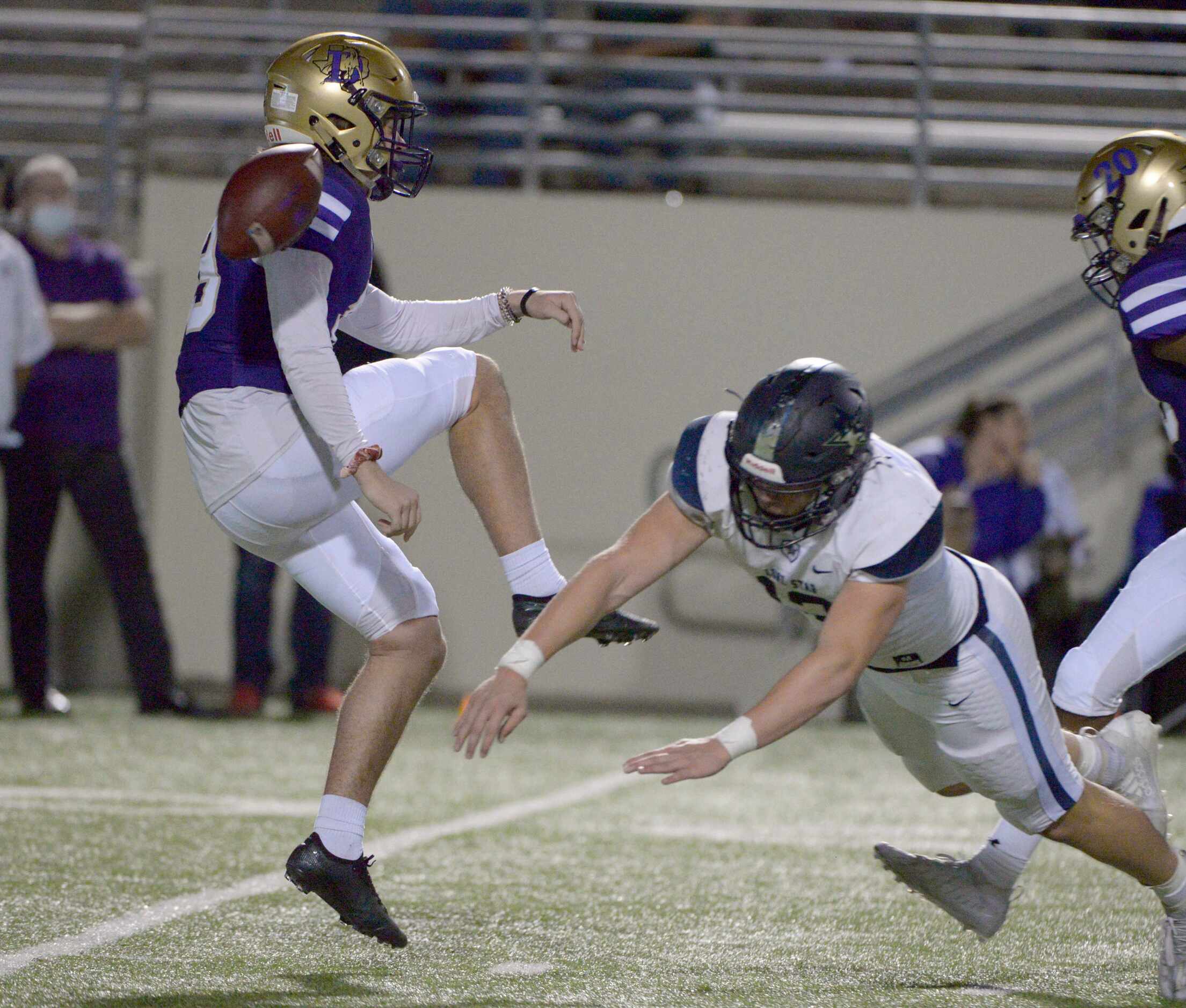 Lone Star’s Blake Gotcher (12) blocks a punt by Denton’s Jonah Lawrence in the first quarter...