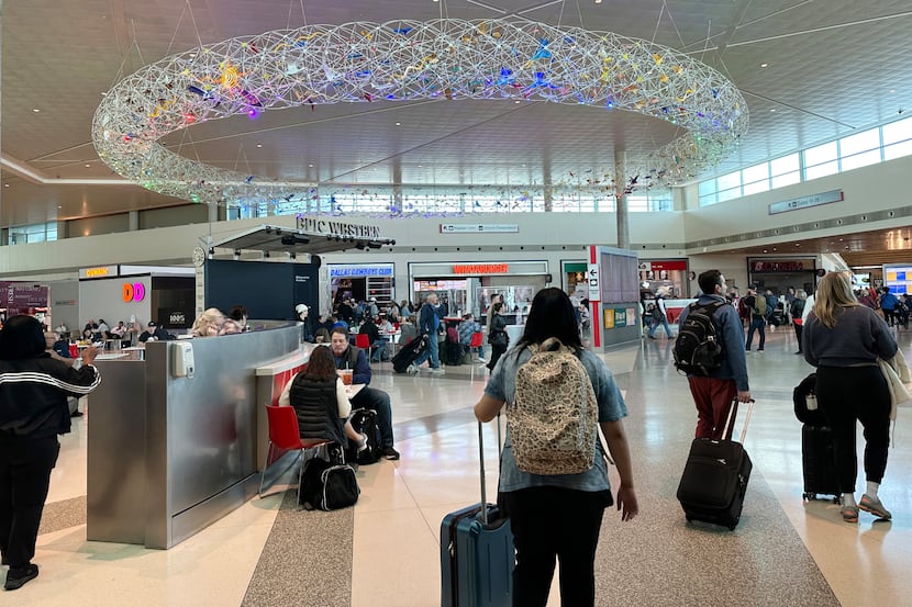 Travelers eat at the terminal at Love Field in Dallas on March 19, 2023.