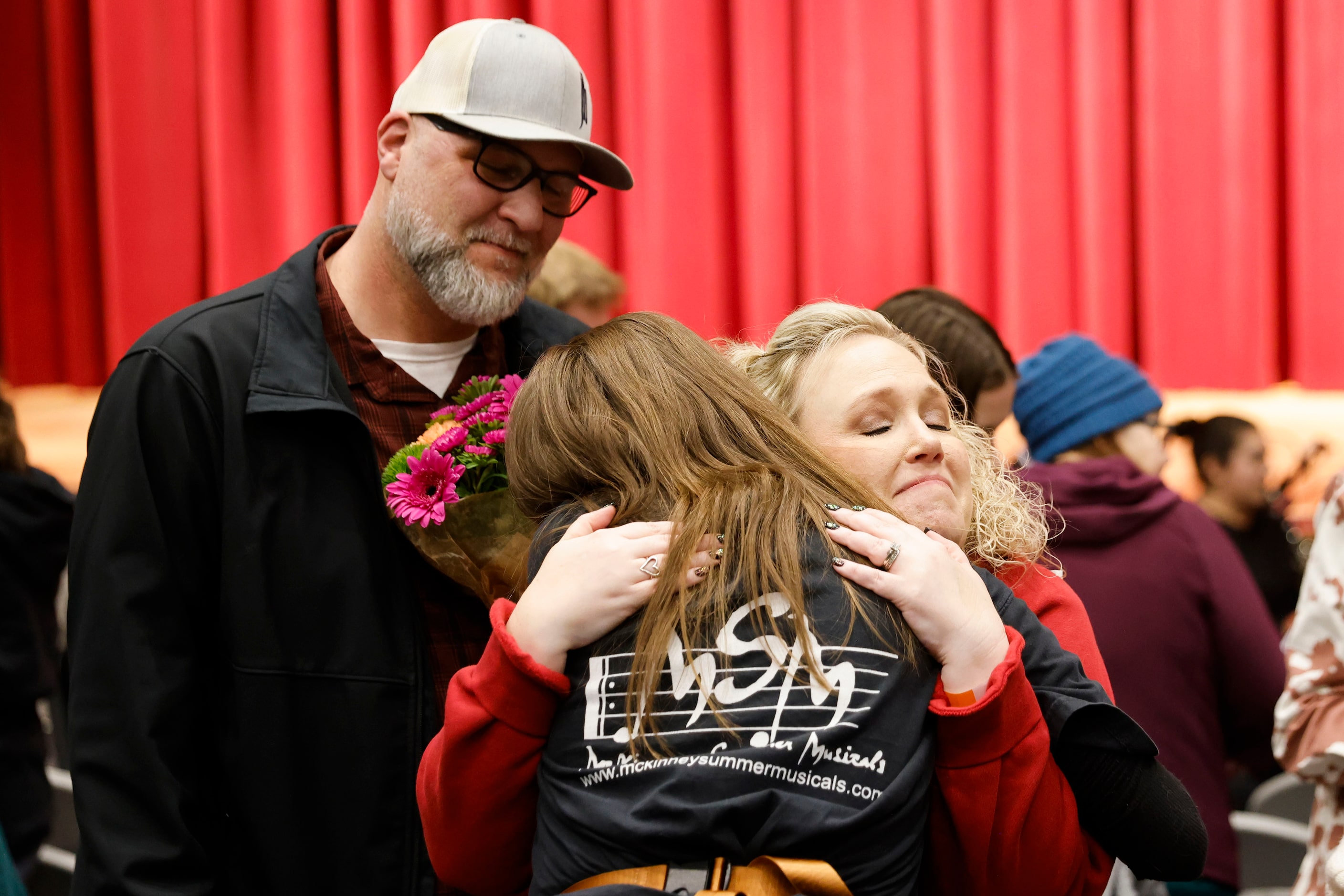 Parents of Max Hightower (not in the photo), Phillip Hightower, (left) watches as Amy...