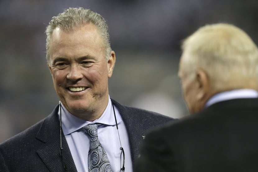 Stephen Jones, left, Dallas Cowboys executive vice president, walks the field in front of...
