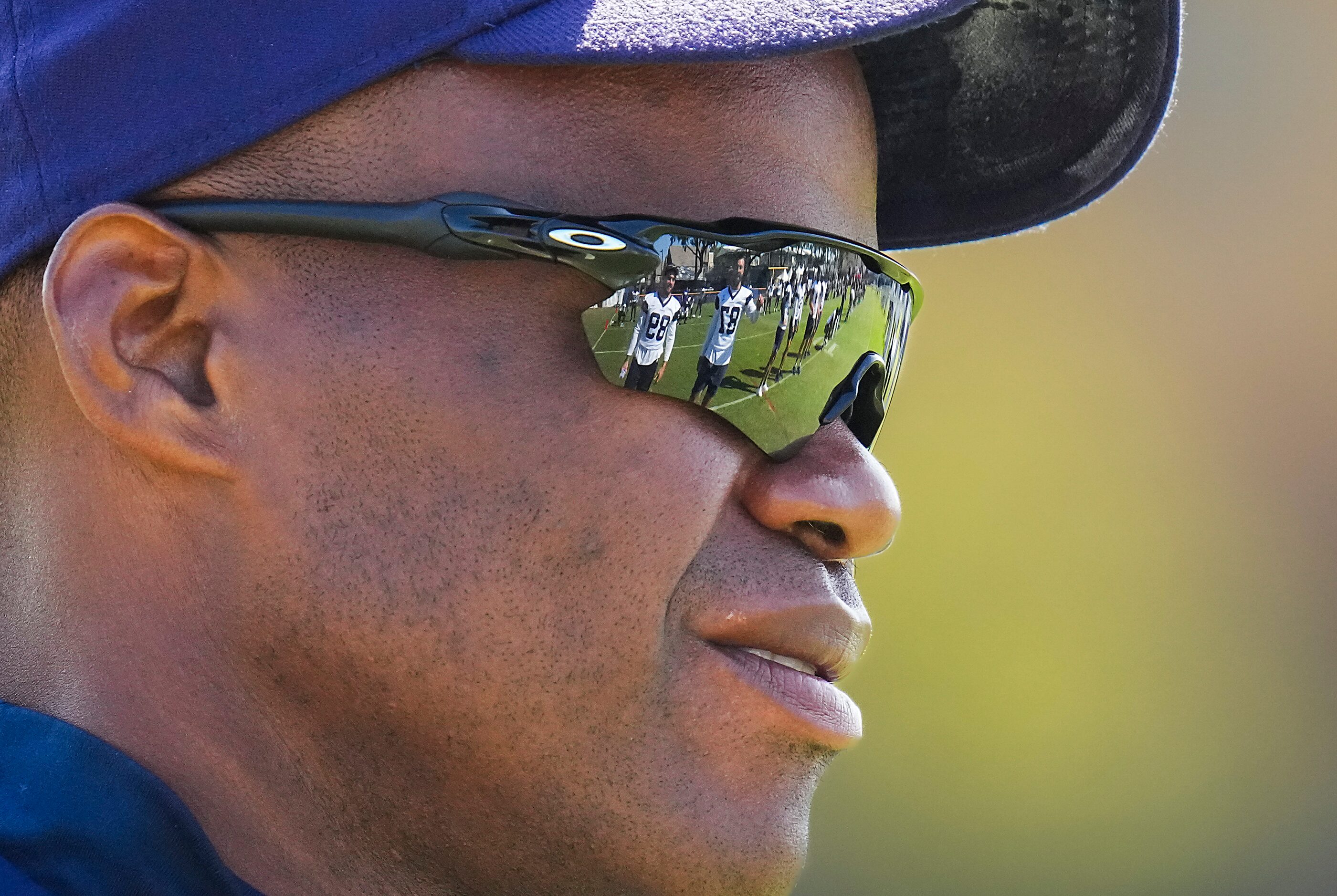 Dallas Cowboys tight ends coach Lunda Wells talks with players (reflected in his sunglasses)...