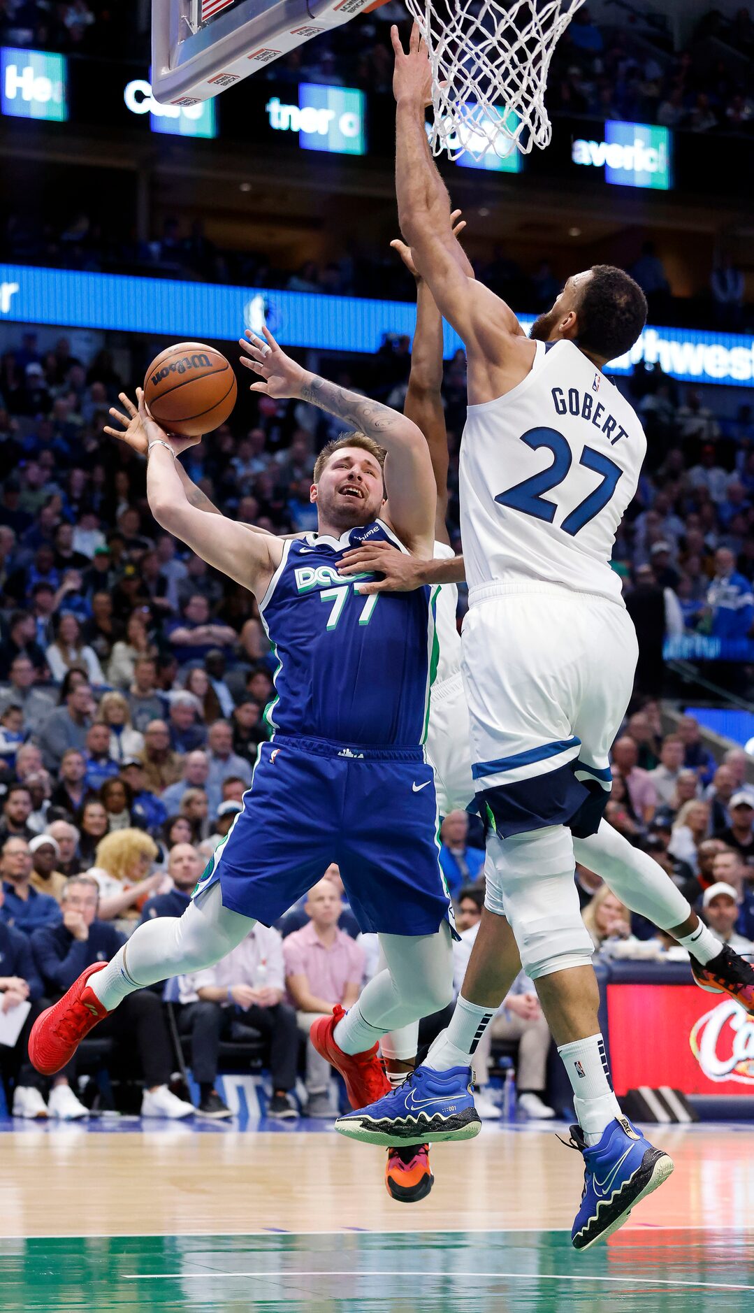 Dallas Mavericks guard Luka Doncic (77) is fouled by Minnesota Timberwolves center Rudy...