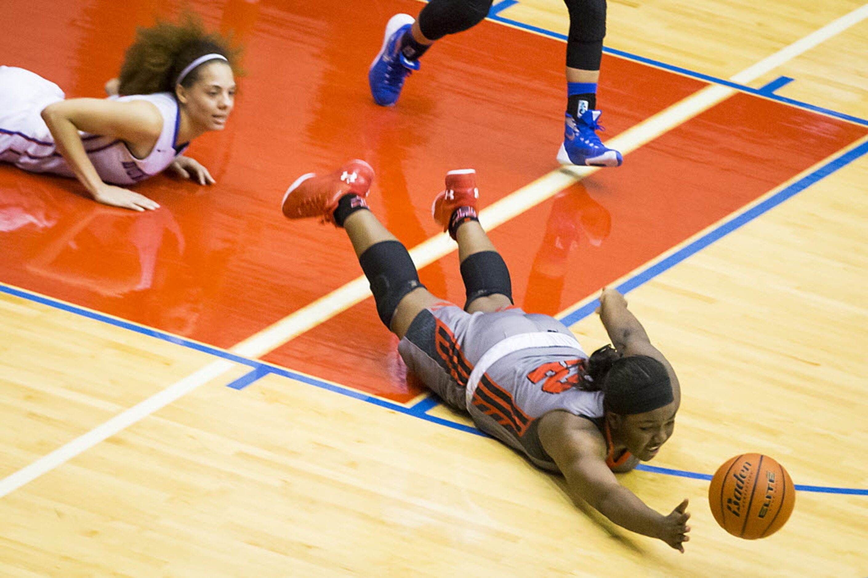 Cedar Hill forward Taylor Hutchins (22) dives for a loose ball past Duncanville forward...