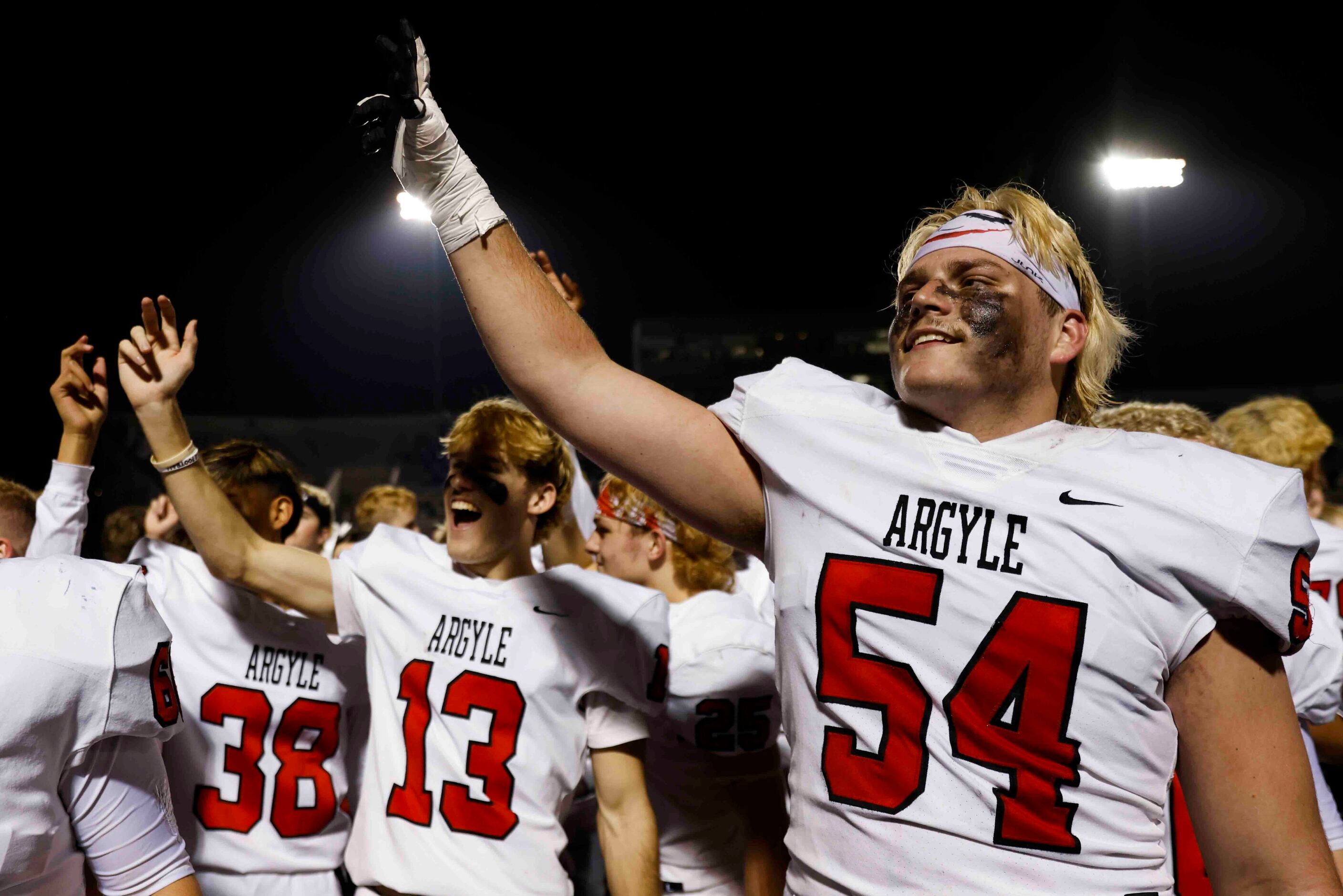 Argyle high players including Wes Tucker (54) celebrate after winning against Grapevine High...