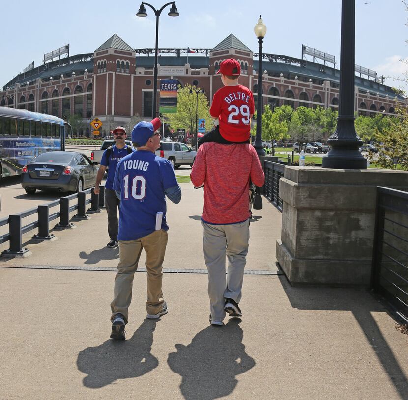 Three generations of baseball fans head to the stadium for mopening day--grandfather Mike...