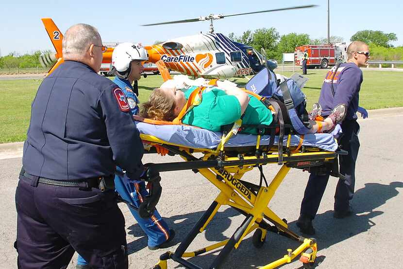  A victim is taken to a CareFlite helicopter during a 2014 disaster drill in Denton. (Al...