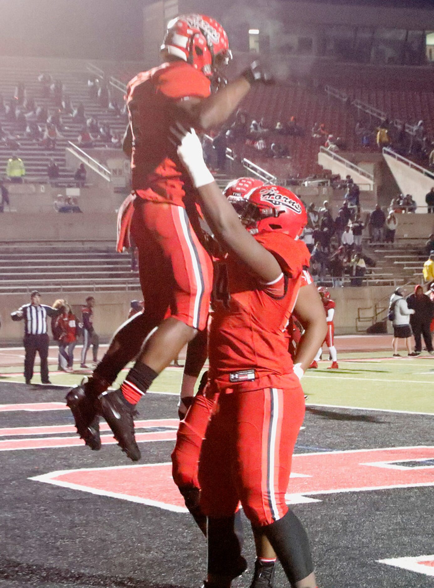 Cedar Hill High School running back Kevin Young Jr. (5) is hoisted up by Cedar Hill High...