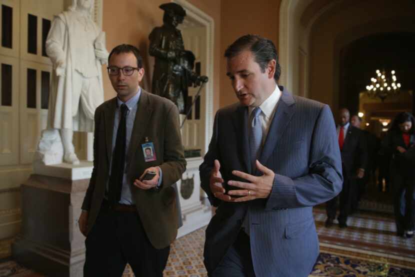 Sen. Ted Cruz (right) talked with a reporter after leaving a Republican Senate caucus...