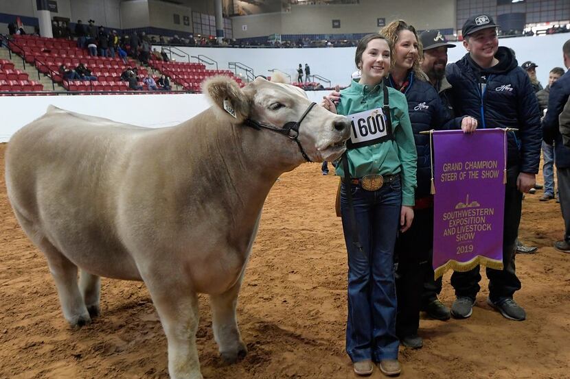 Aven Horn and family members pose for a photo after Horn's steer, Bentley, was named the...
