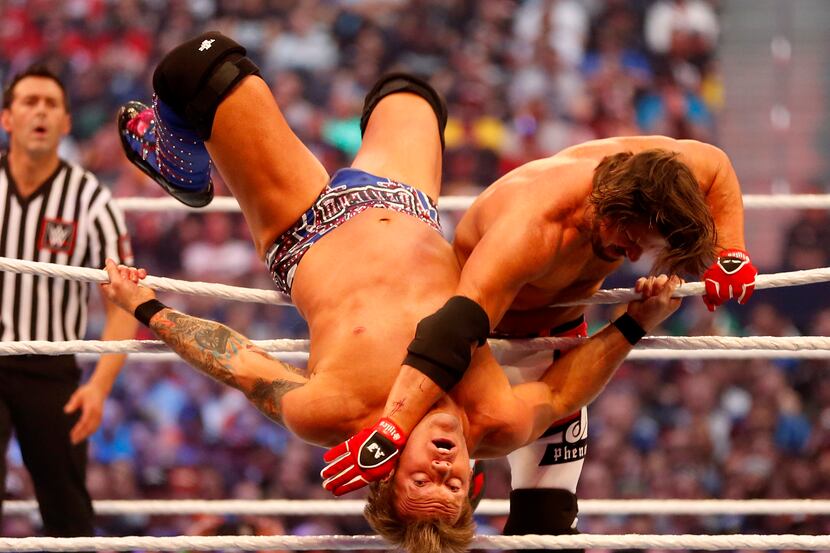 AJ Styles (right) wrestles with Chris Jericho during WrestleMania 32 at AT&T Stadium in...
