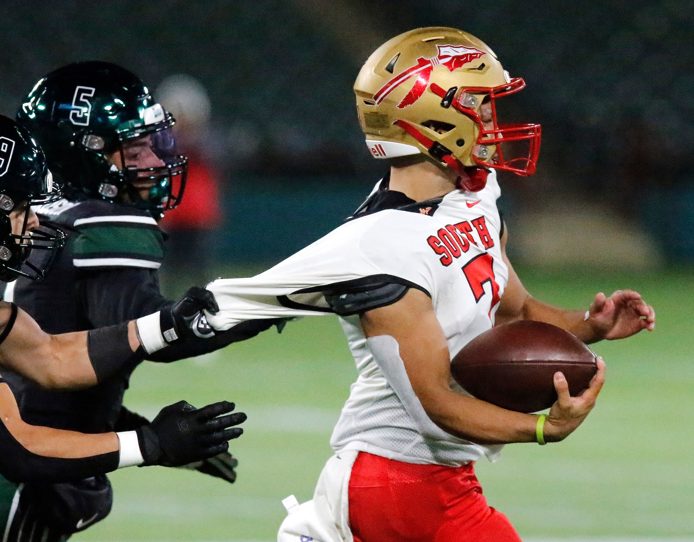 South Grand Prairie High School quarterback Jaden Stanley (7) has his jersey stretched by...