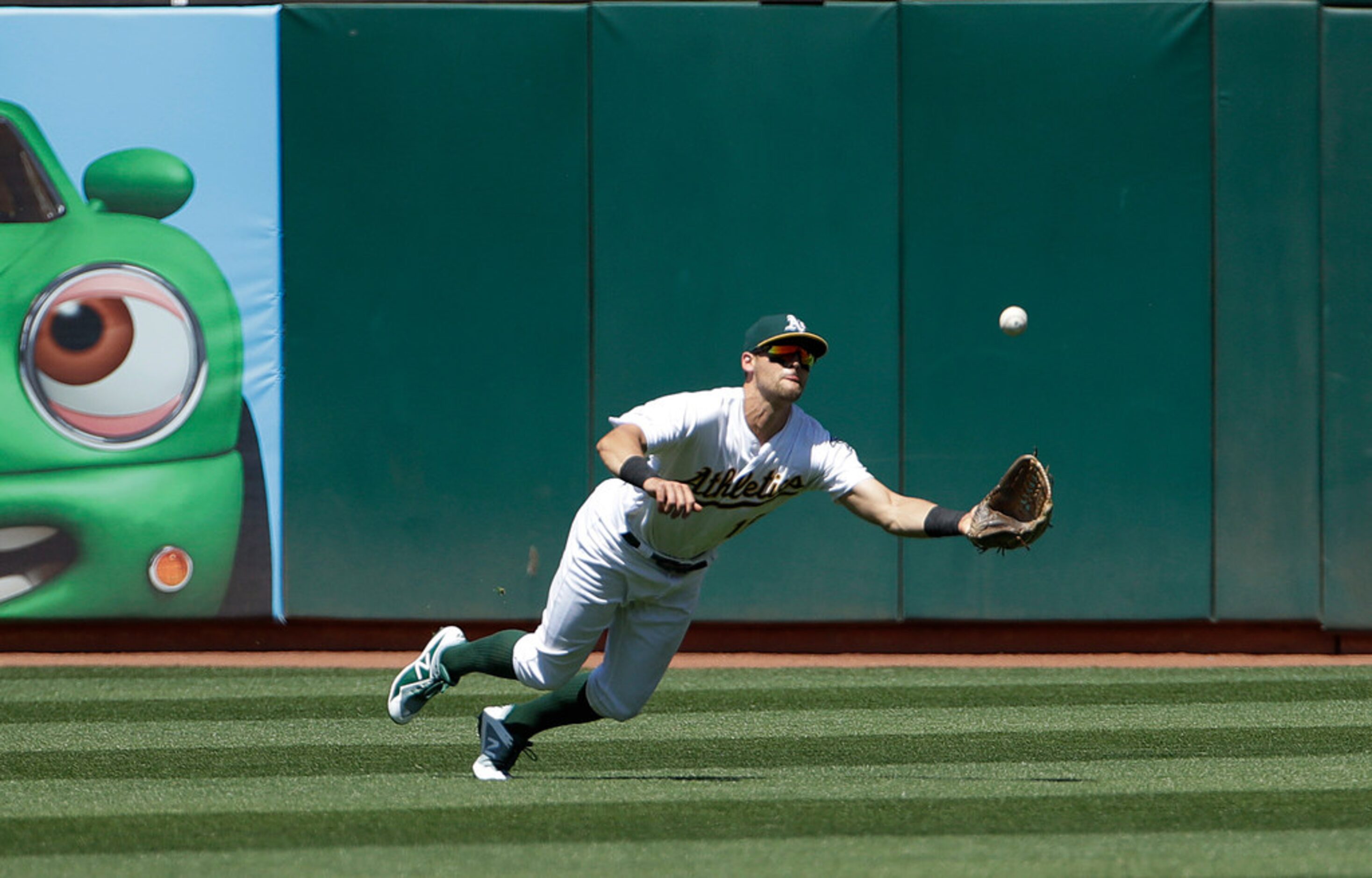 Oakland Athletics left fielder Chad Pinder catches a fly ball hit by Texas Rangers' Shin-Soo...