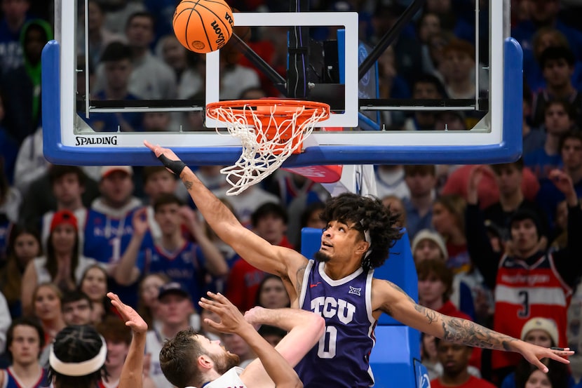 TCU guard Micah Peavy (0) tries to block a Kansas shot during the second half of an NCAA...