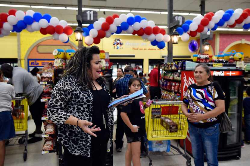 Poet and actress Priscilla Rice, 43, of Dallas reads her poetry to families waiting to pay...