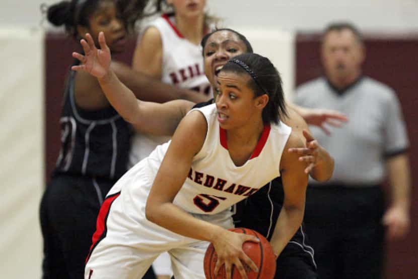 Frisco LIberty High School's Kayla Mundy (5) looks for an outlet pass as she is defended by...
