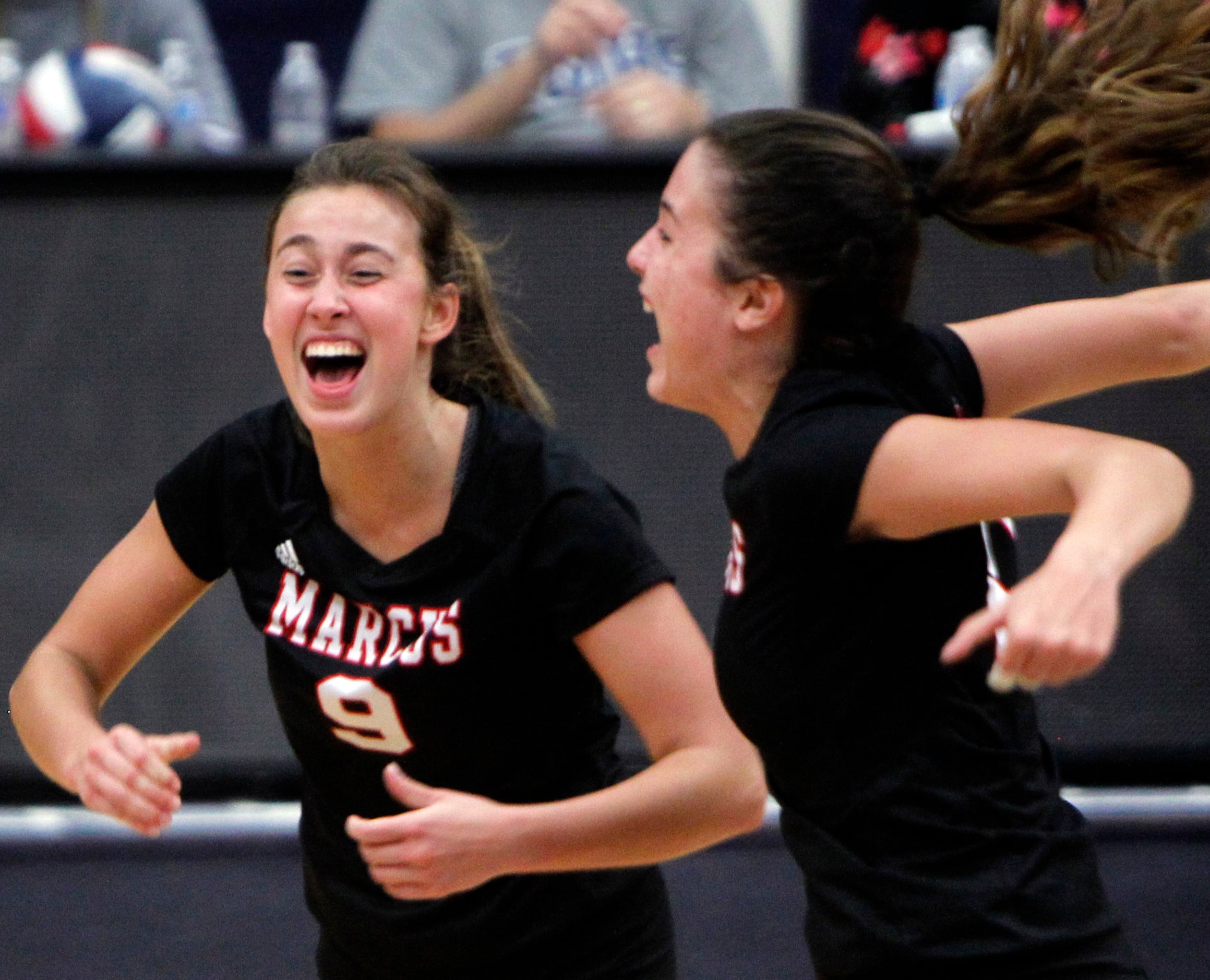 Flower Mound Marcus' Maggie Cox (9), left, reacts along with teammate Rachel Sturton (10)...