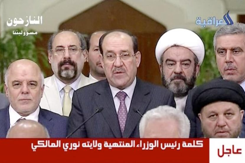 Iraq’s prime minister  for the past eight years, Nouri al-Maliki (center), relinquished his...