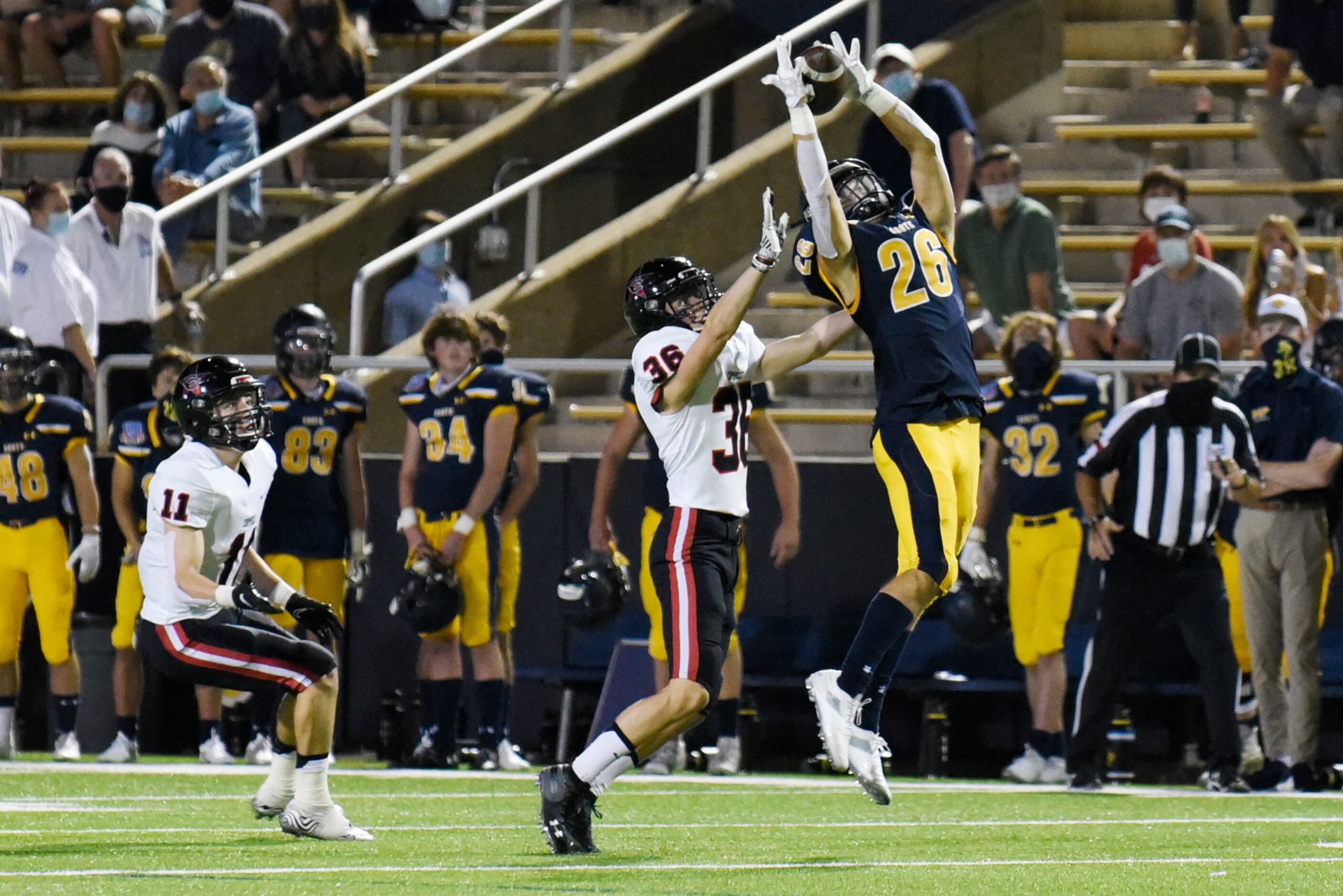 Highland Park receiver Luke Rossley (26) jumps for a catch but has the ball knocked out of...