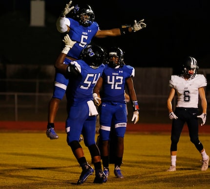 Trinity Christian-Cedar Hill player Qualan Jones (6) celebrates a rushing touchdown against...