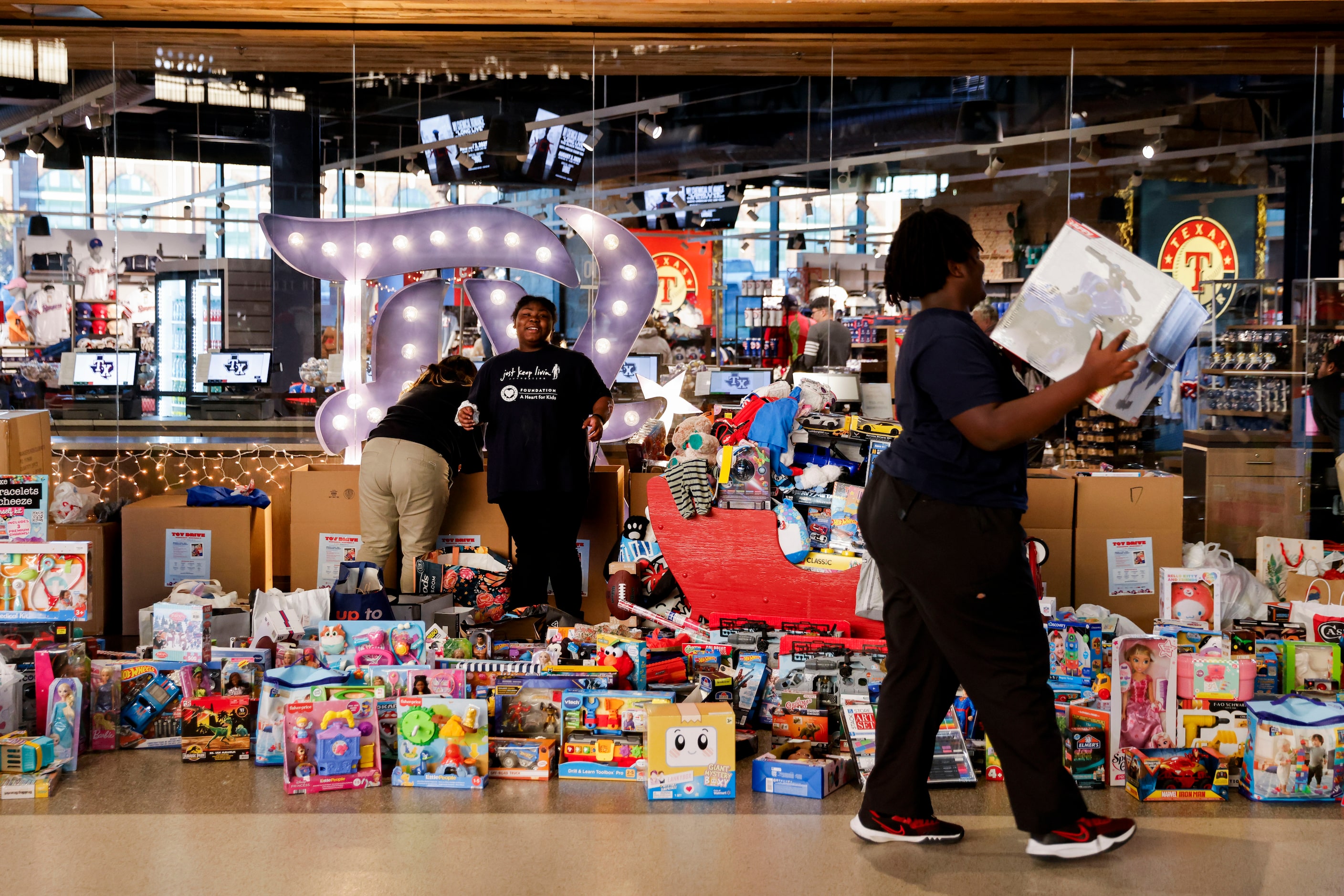 Gathered toys brought in by the crowd remain in front of the  Grand Slam Team Store during...