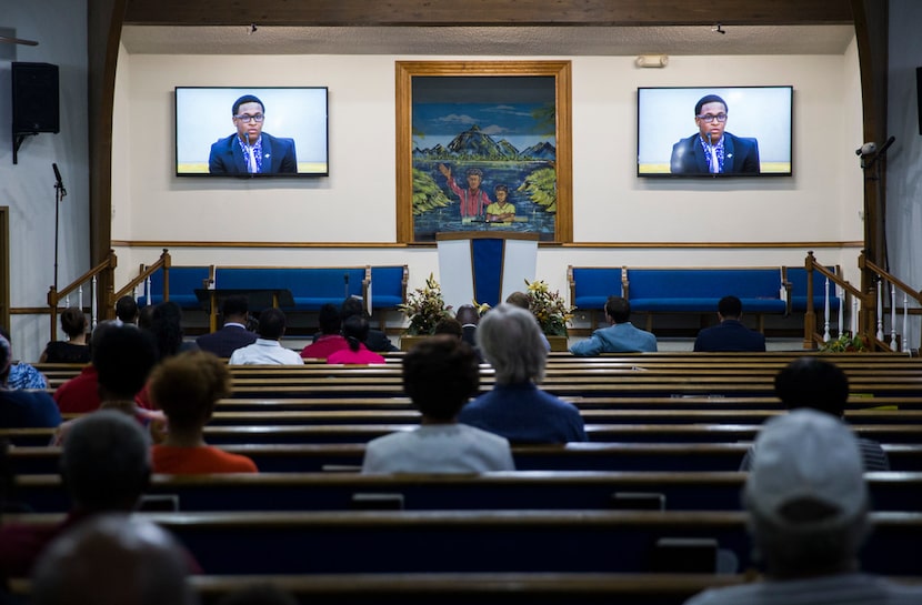 A video of Brandt Jean, Botham Jean's brother, plays at a church service where Bertrum Jean...