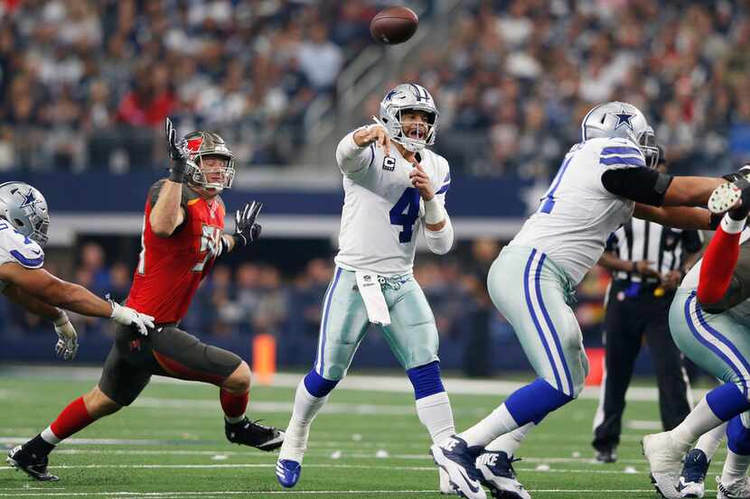 FILE - Cowboys quarterback Dak Prescott (4) attempts a pass as Tampa Bay Buccaneers...