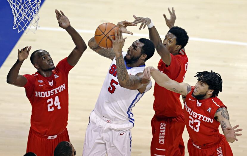 Southern Methodist Mustangs forward Markus Kennedy (5) goes up against Houston Cougars...