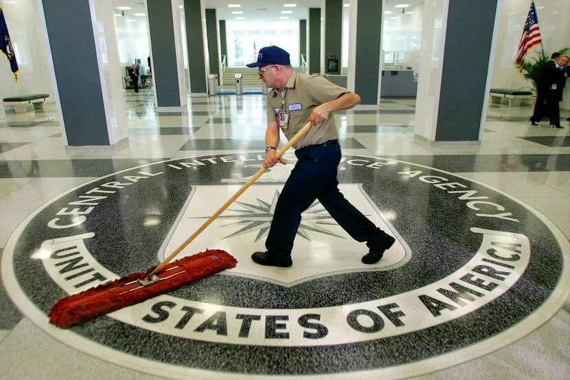FILE - A workman quickly slides a dustmop over the floor at the Central Intelligence Agency...