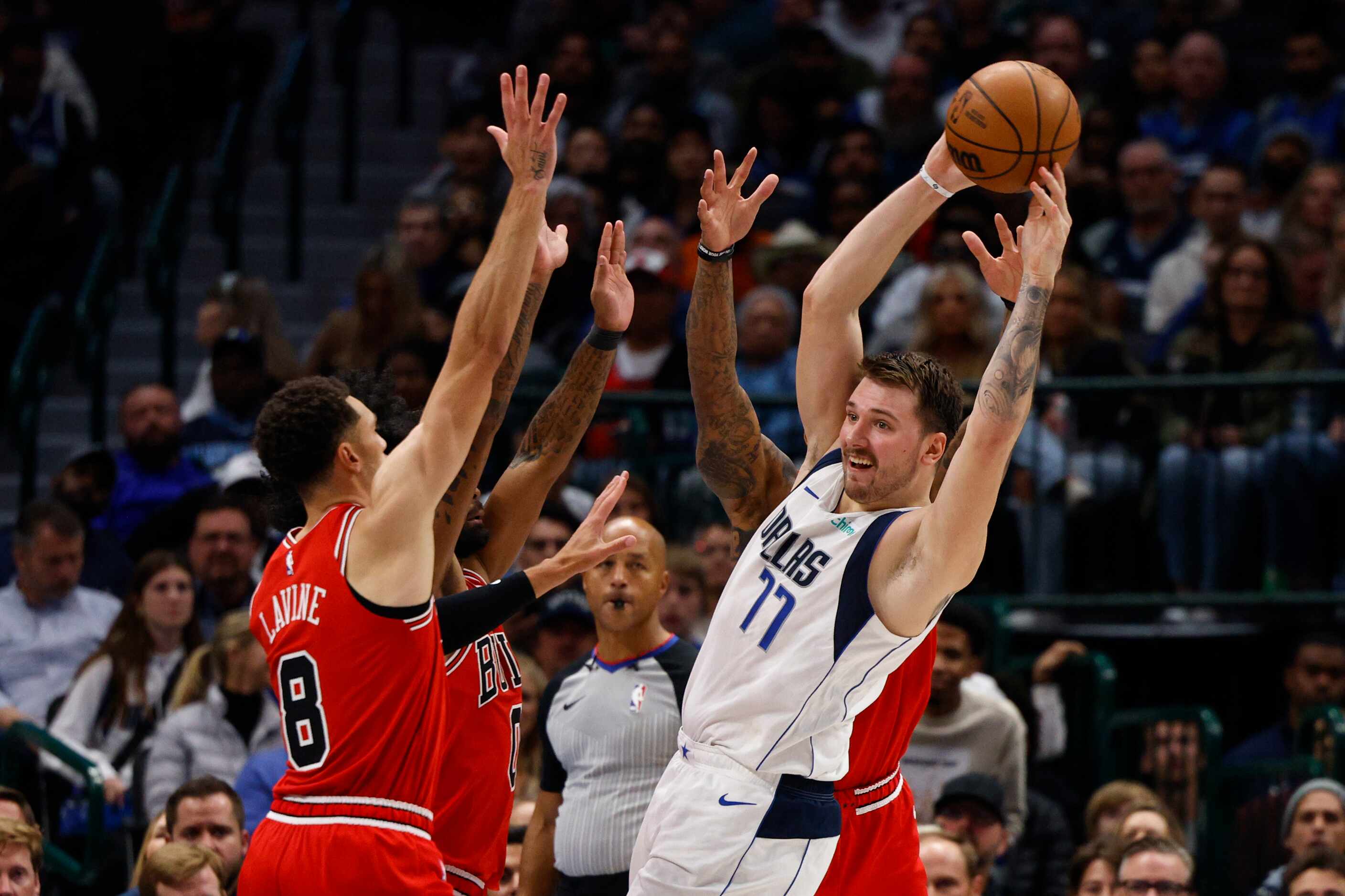 The Chicago Bulls force Dallas Mavericks guard Luka Doncic (77) to pass out of a triple team...