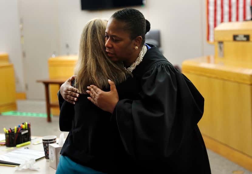Judge Tammy Kemp gives Amber Guyger a hug after the former officer is sentenced to 10 years...