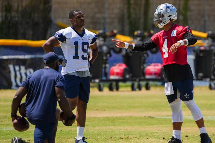 Dallas Cowboys quarterback Dak Prescott (4) works with wide receiver Amari Cooper (19) to...