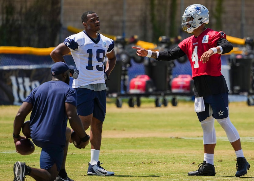 Dallas Cowboys quarterback Dak Prescott (4) works with wide receiver Amari Cooper (19) to...