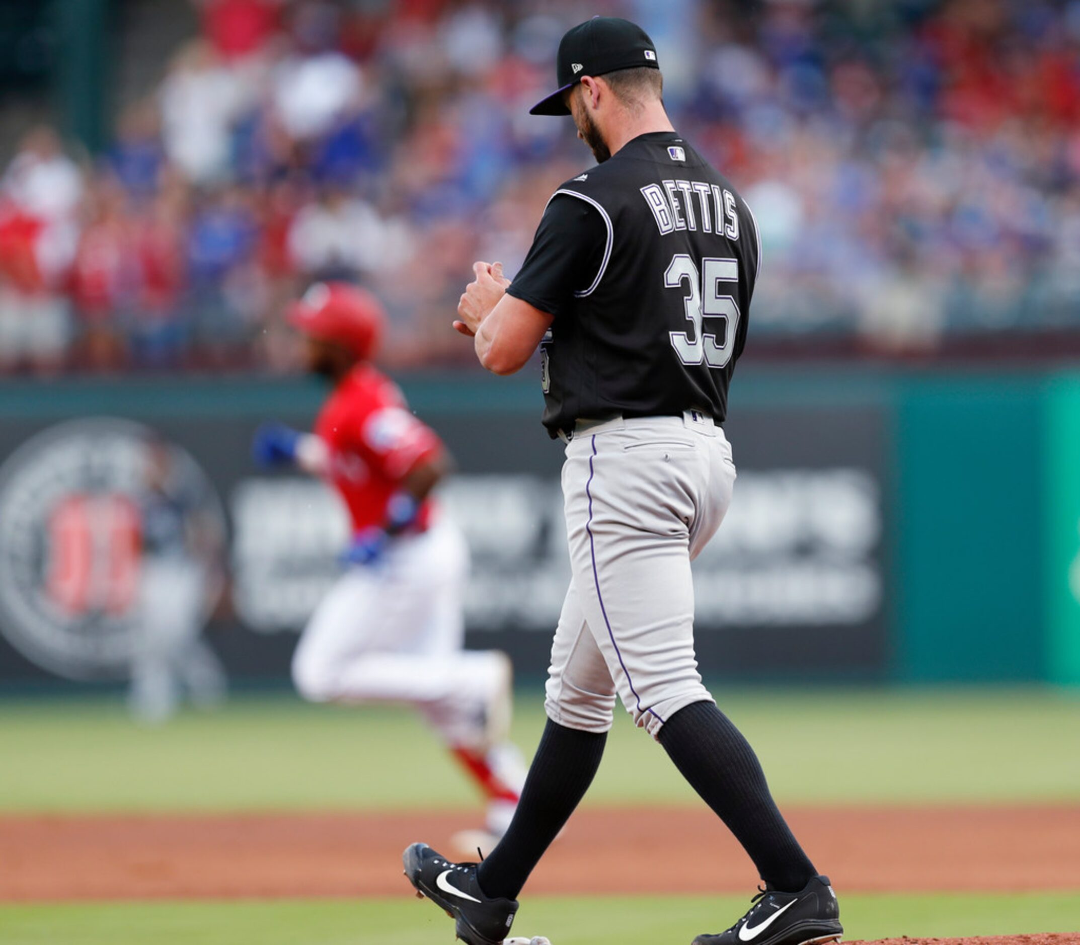 Colorado Rockies starting pitcher Chad Bettis (35) walks to the mound after giving up a...