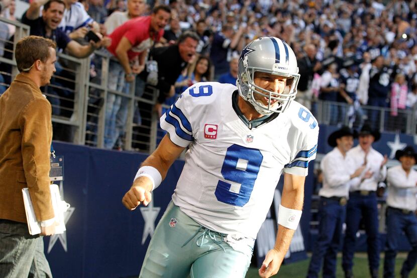 Dallas Cowboys quarterback Tony Romo (9) celebrates after scoring a touchdown on fourth down...