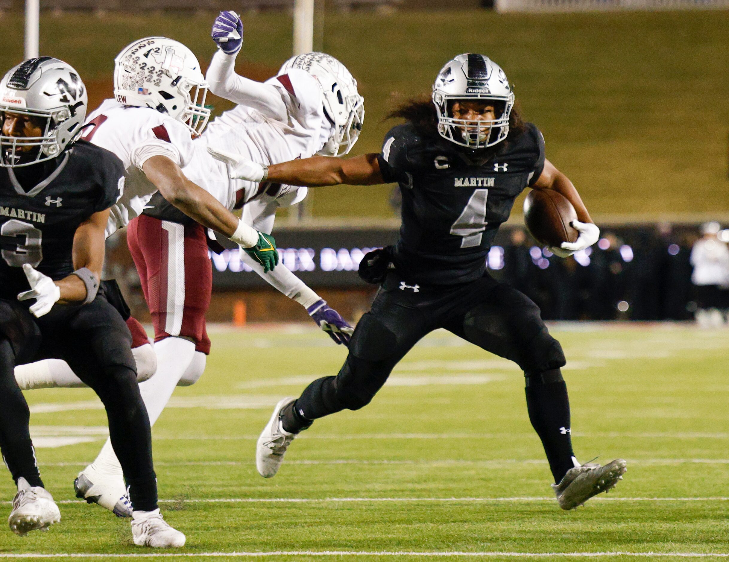 Arlington Martin wide receiver Michael Barrow (4) runs past a trio of Lewisville defenders...