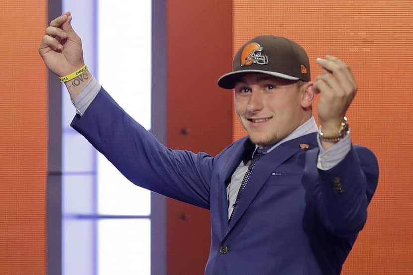 Texas A&M quarterback Johnny Manziel reacts after being selected by the Cleveland Browns as...