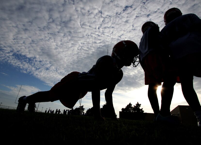 A member of the Cedar Hill Longhorns completes a few pushups following a drill. 