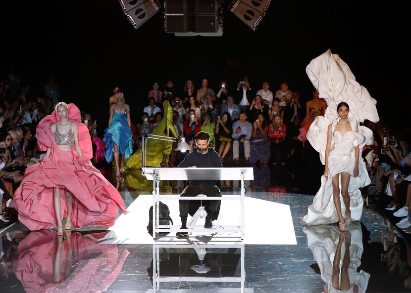 Models present creations next to fashion designer for Schiaparelli Daniel Roseberry (center)...