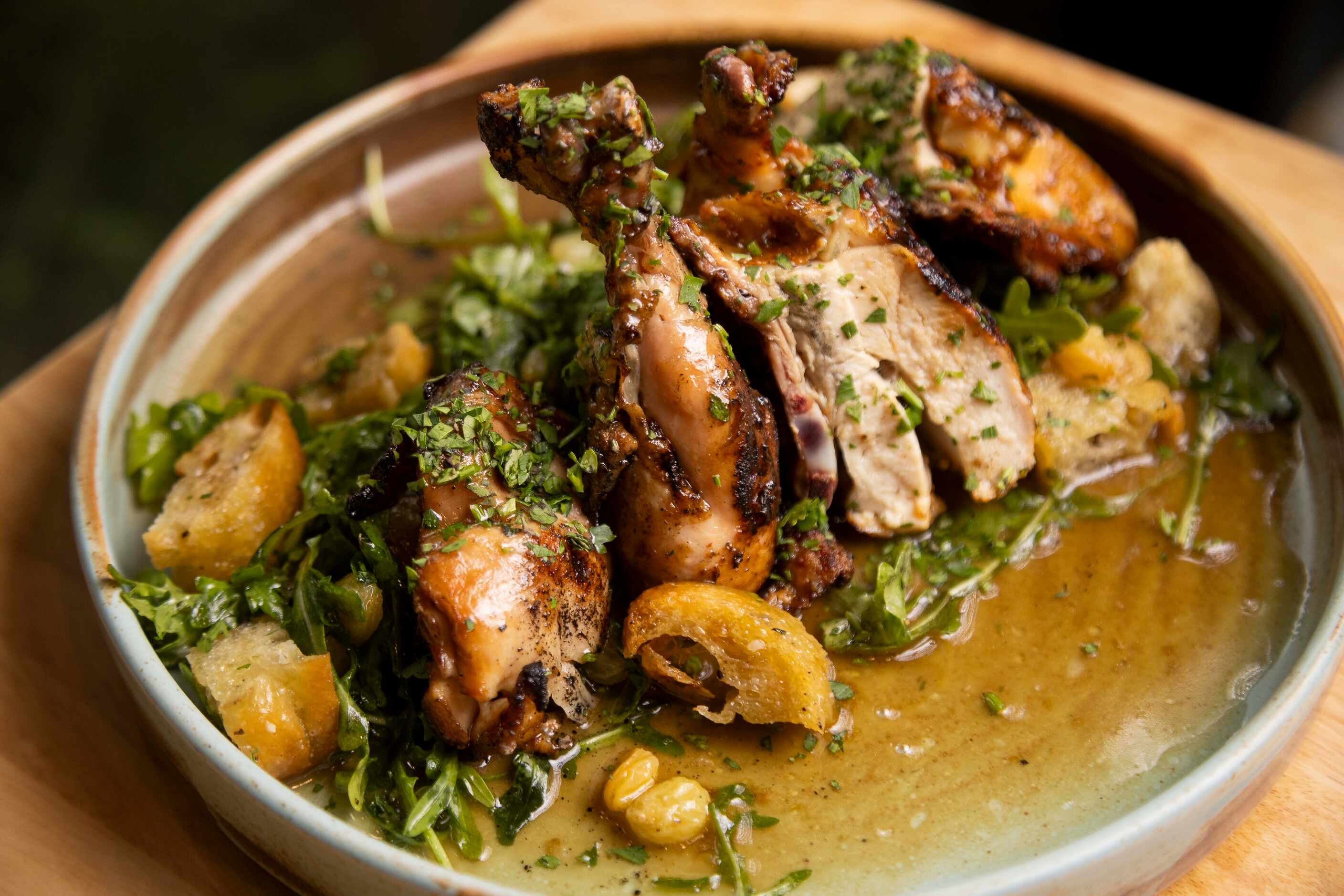 The Pollo alla Griglia is wood-fired and served with a warm bread salad made with toasted...