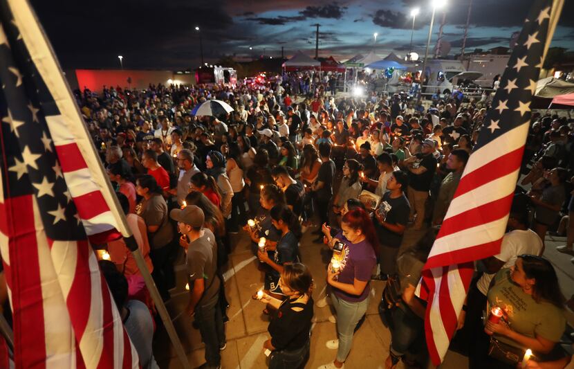 EL PASO, TEXAS - AUGUST 07: People attend a candlelight vigil at a makeshift memorial...