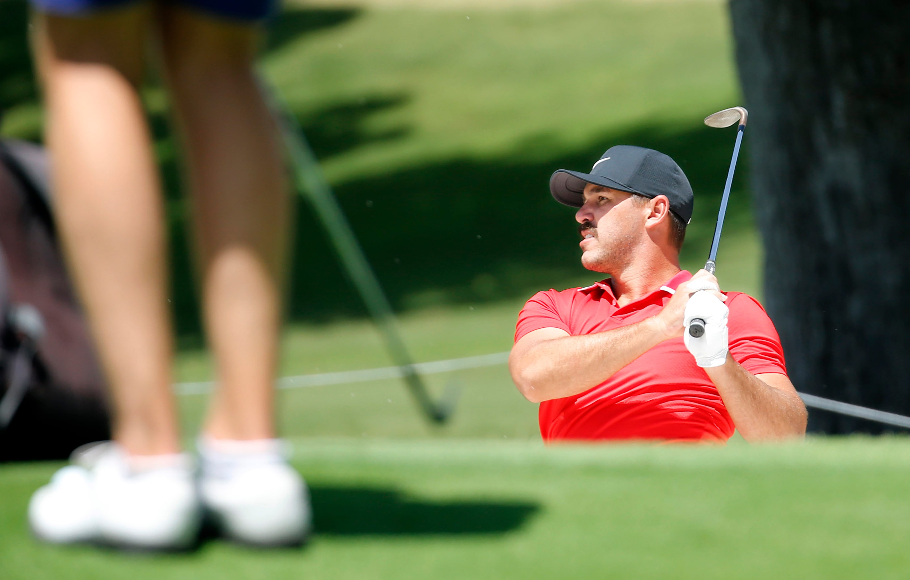 PGA golfer Brooks Koepka hits out of the No. 11 green side bunker during the Charles Schwab...