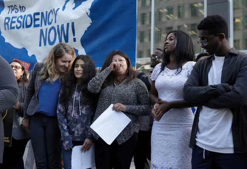 Emi MacLean (left), attorney with the National Day Laborer Organizing Network, stands next...