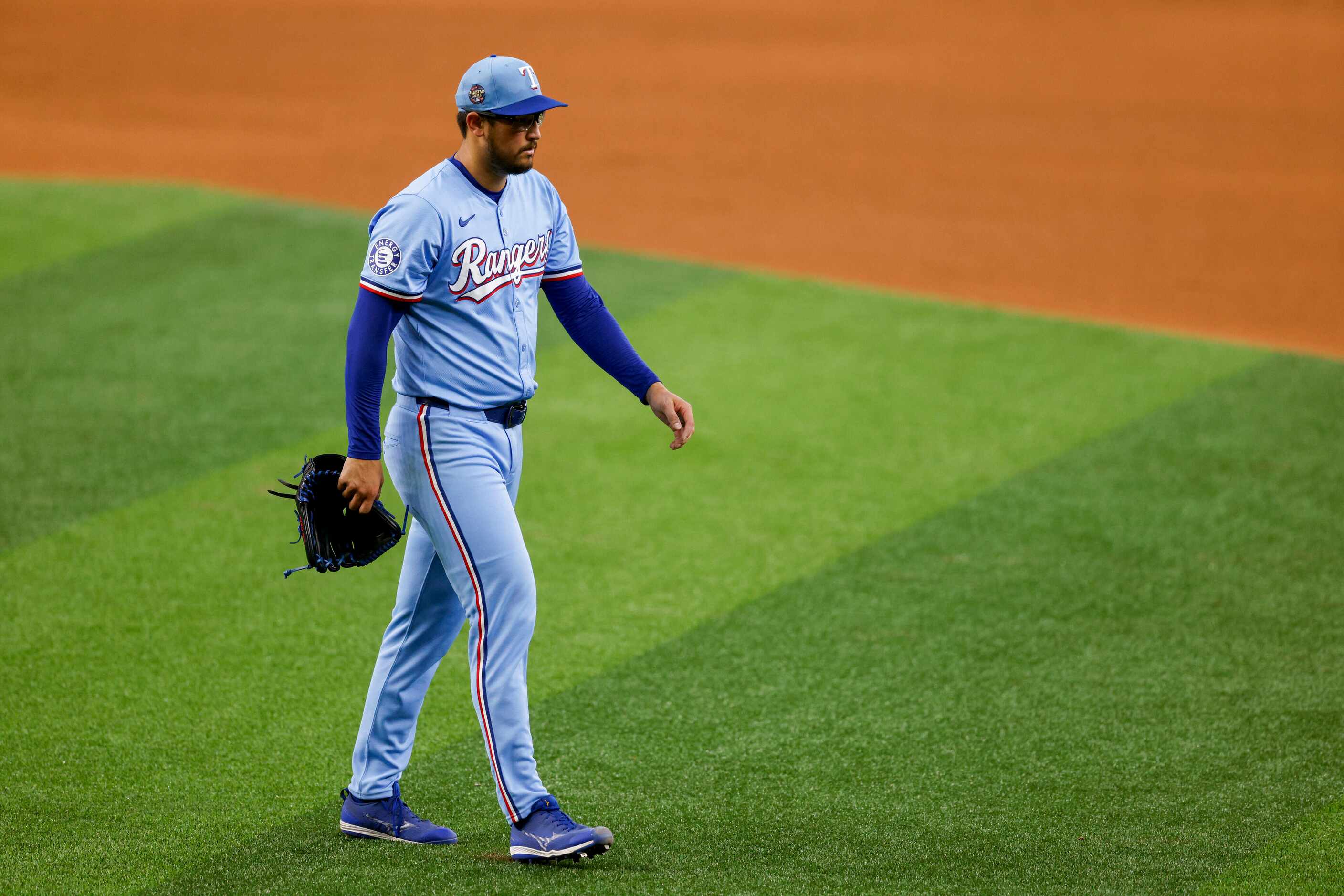 Texas Rangers pitcher Dane Dunning (33) walks to the dugout after being pulled during the...