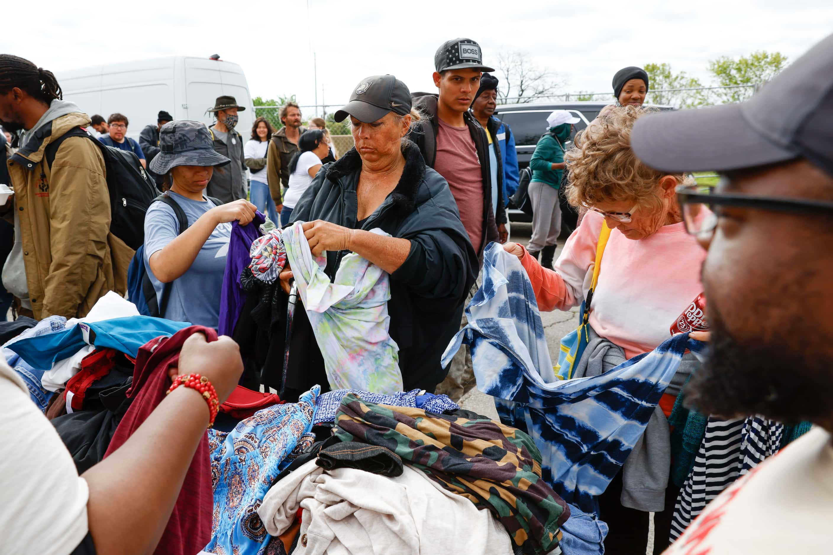 People gather to collect clothings during the first city-sanctioned street feeding event...