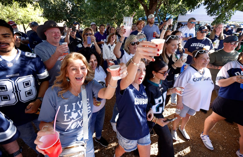 Longtime Dallas Cowboys fans raise a Fireball shot as Lot 4 Gate 6 Tailgaters co-founder Cy...