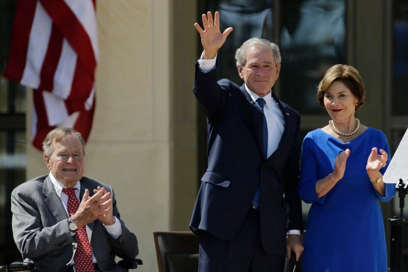 FILE - In this April 25, 2013, file photo, Former President George H.W. Bush, left, applauds...