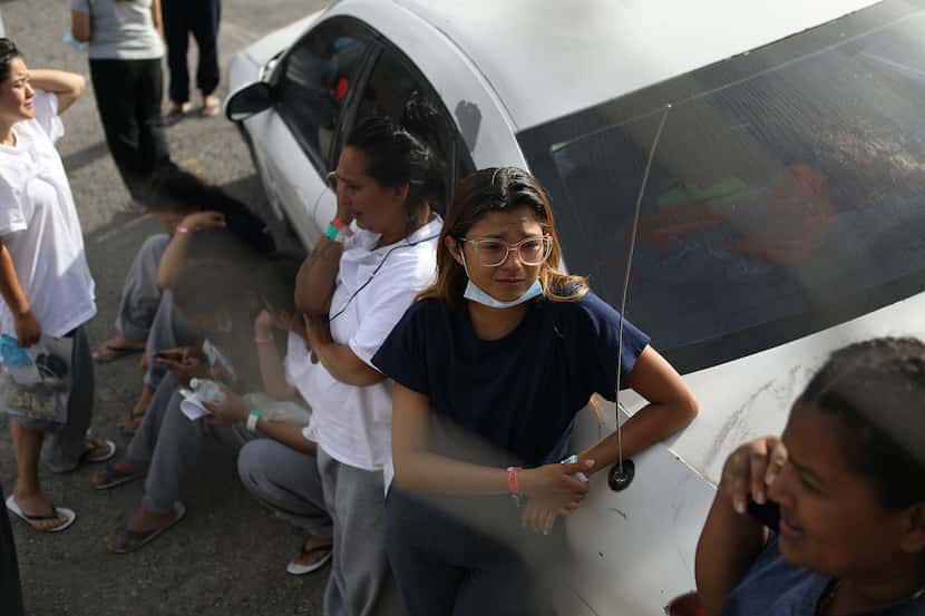 Two women cry as they were expelled from El Paso, Texas, to Ciudad Juárez after a new policy...