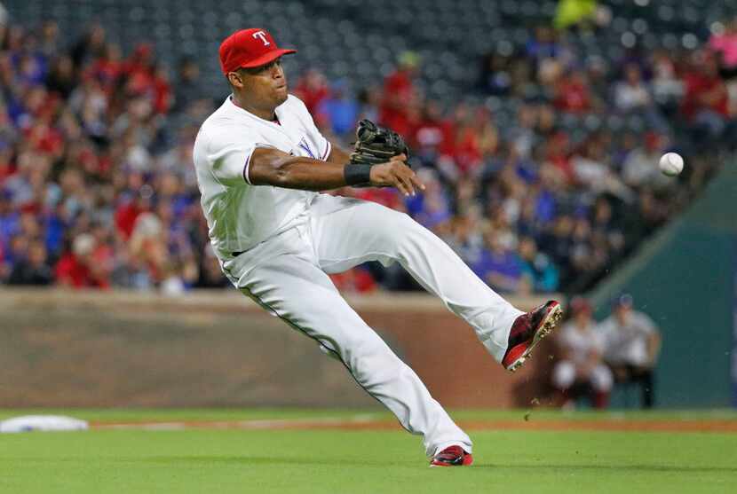 Texas Rangers third baseman Adrian Beltre (29) fields a sacrifice bunt by Milwaukee Brewers...