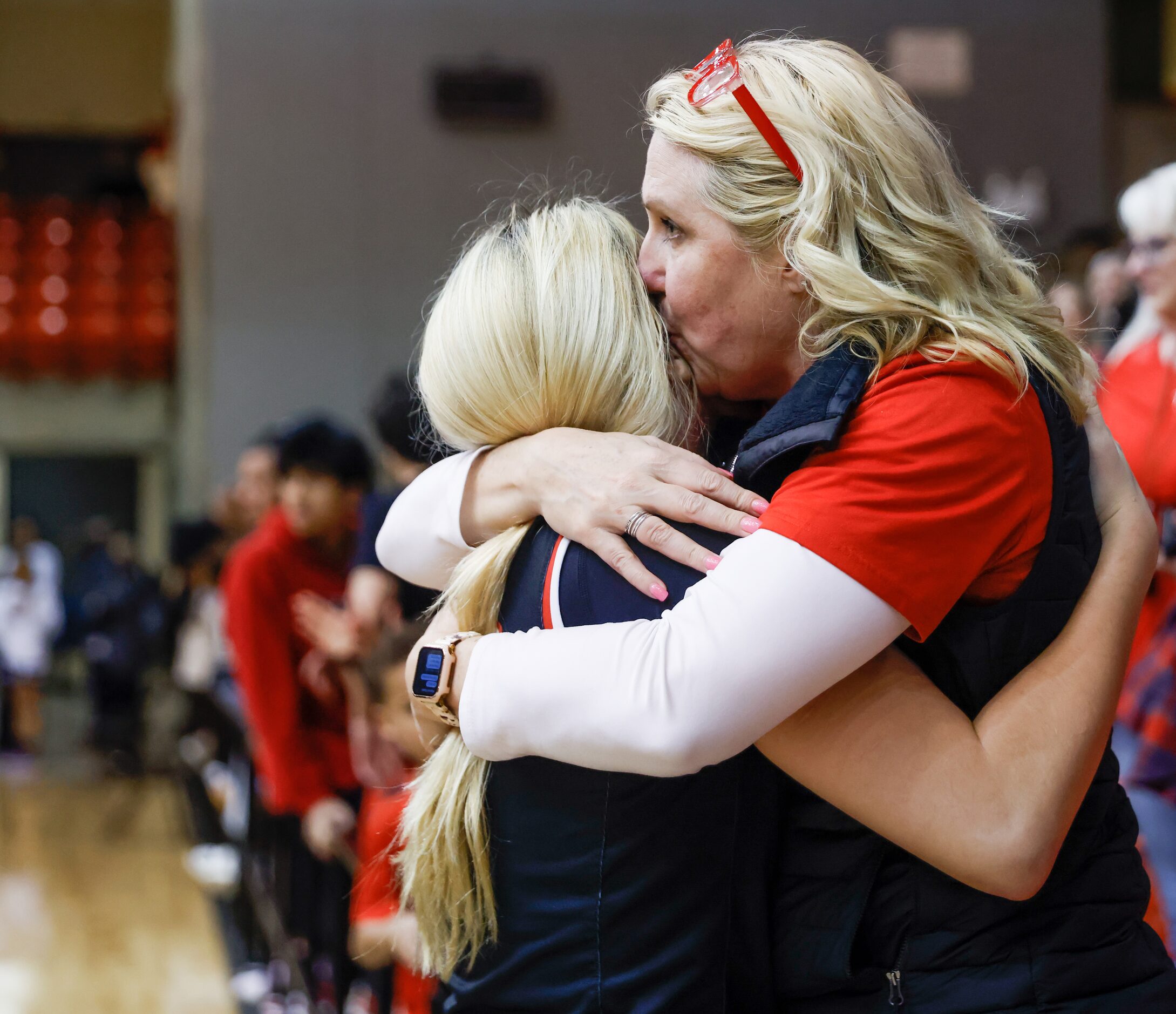 Coppell senior guard Julianna LaMendola (20) and mother Janice LaMedola embrace after...