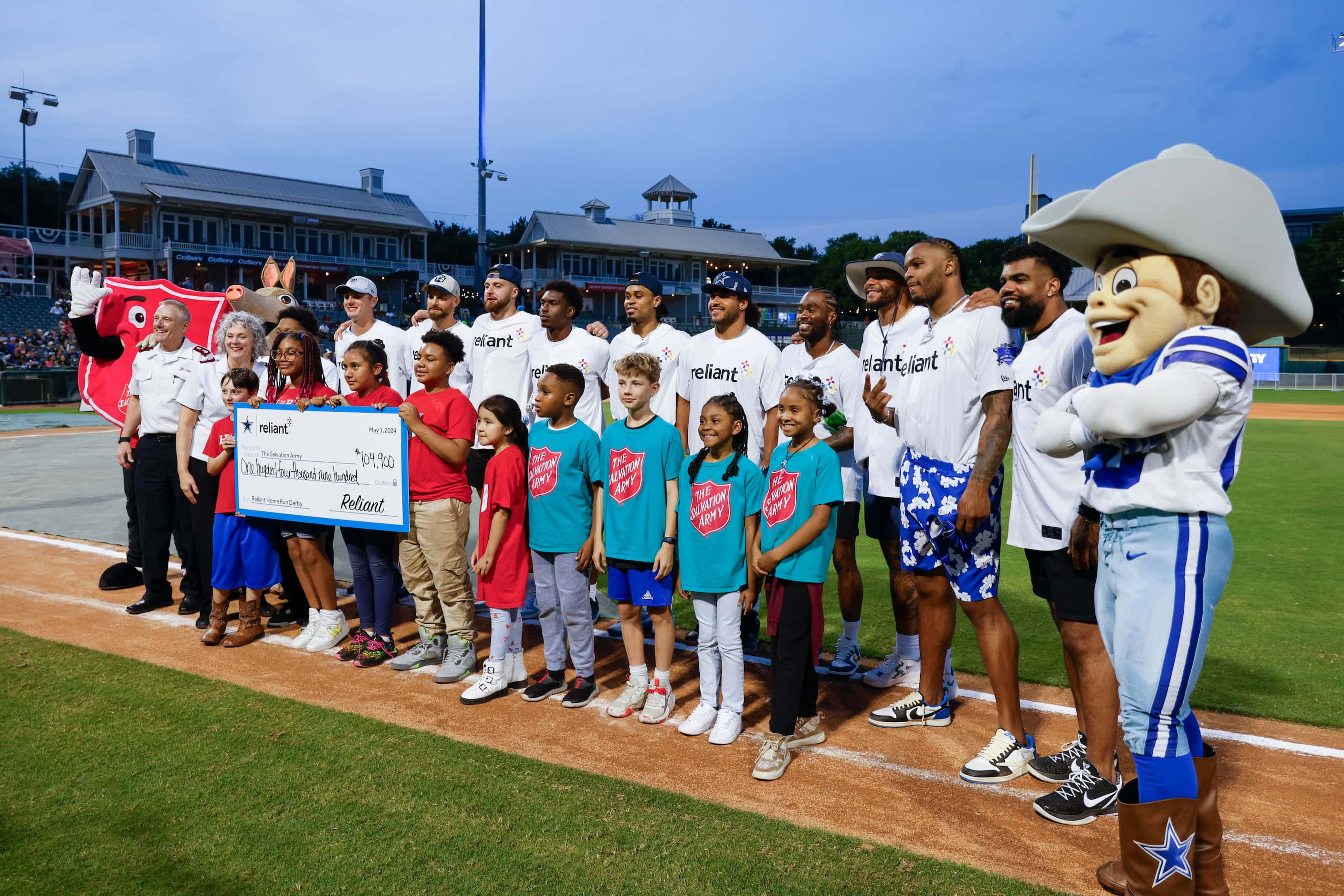 Young fans and Dallas Cowboys players pose for a photo during the presentation of the annual...